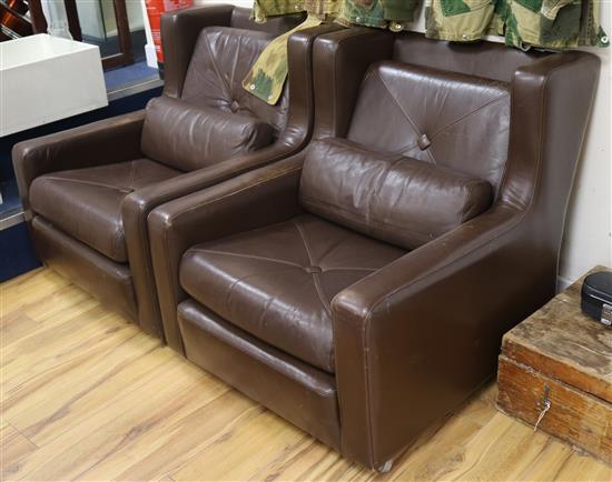 A pair of Danish brown leather armchairs